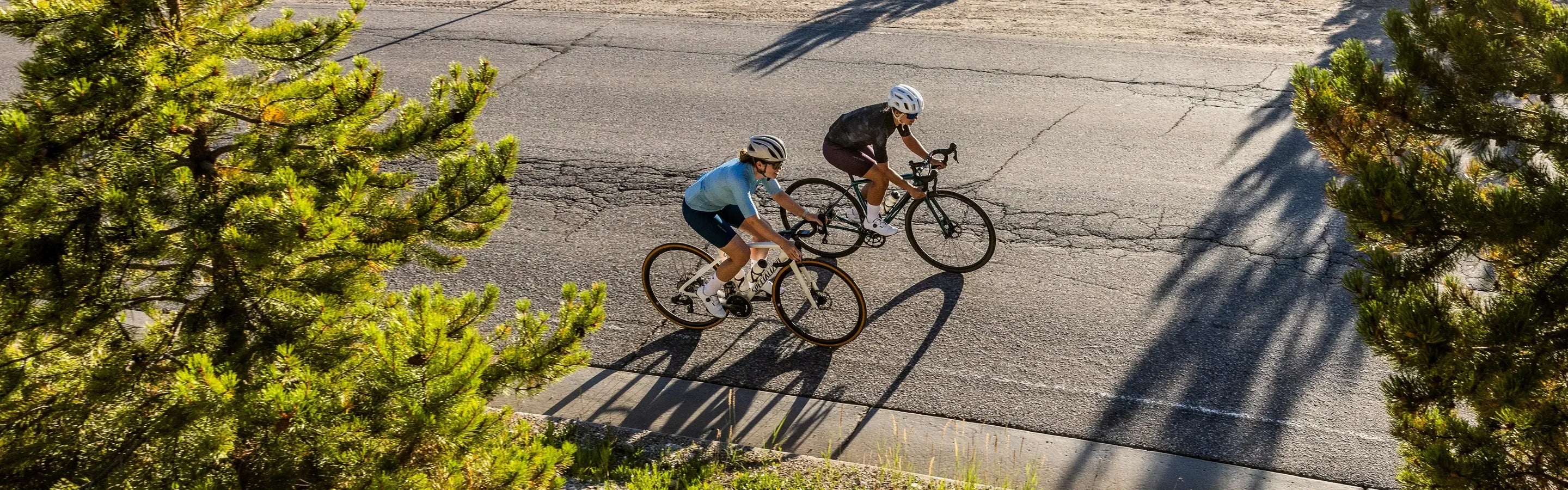 above view of two cyclists riding bicycles on a road